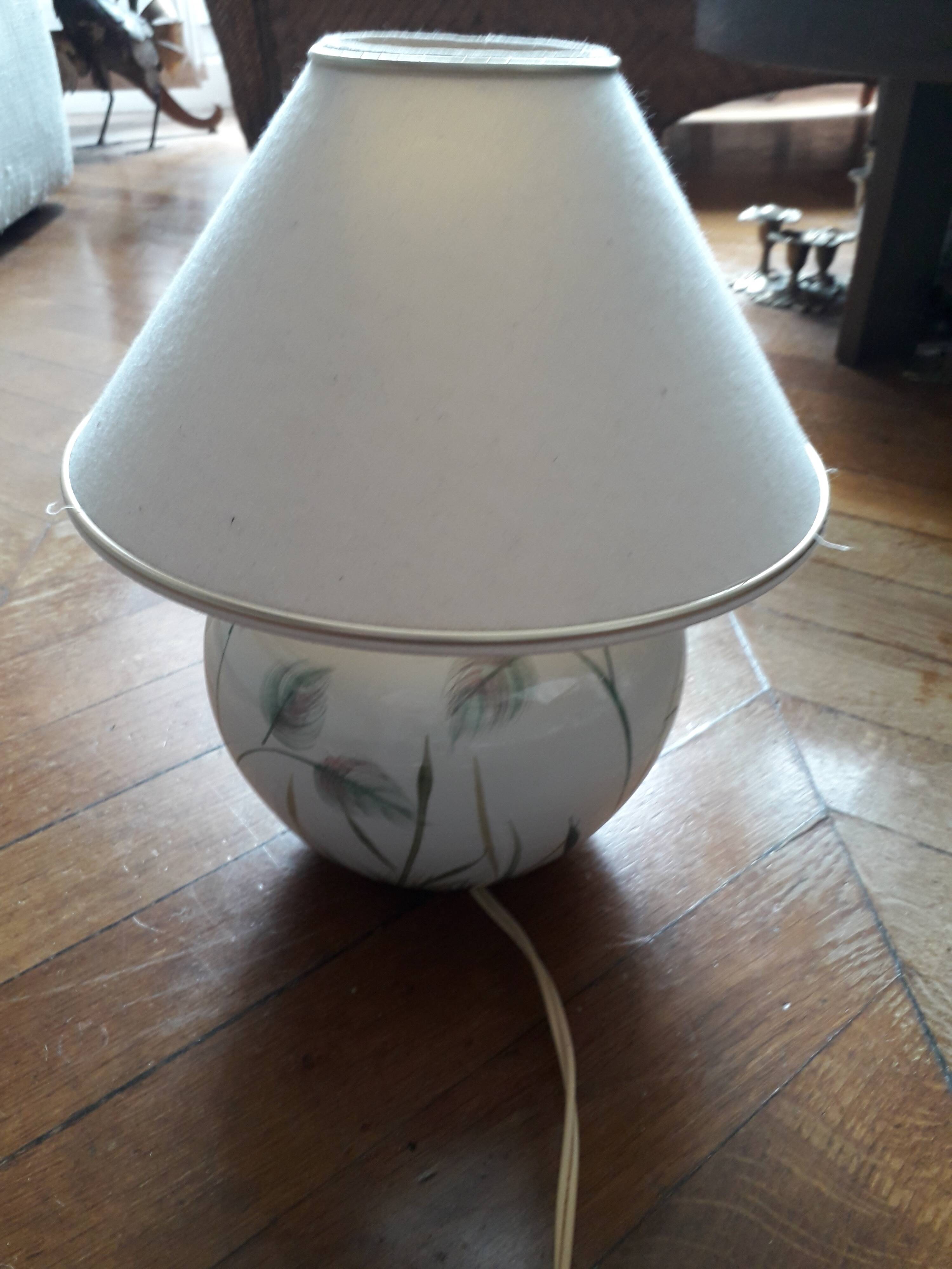 Antique ceramic lamp with a floral design.