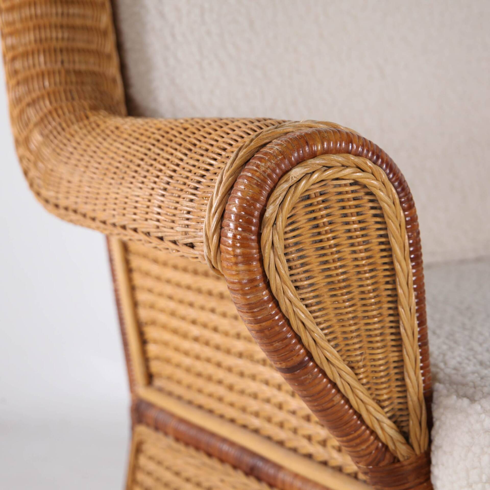 Large wicker armchair and its ottoman