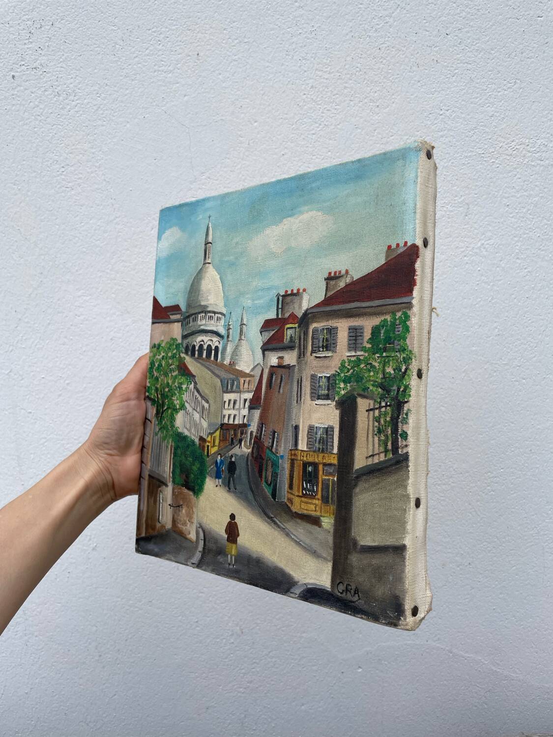 Old oil painting depicting a street in Montmartre