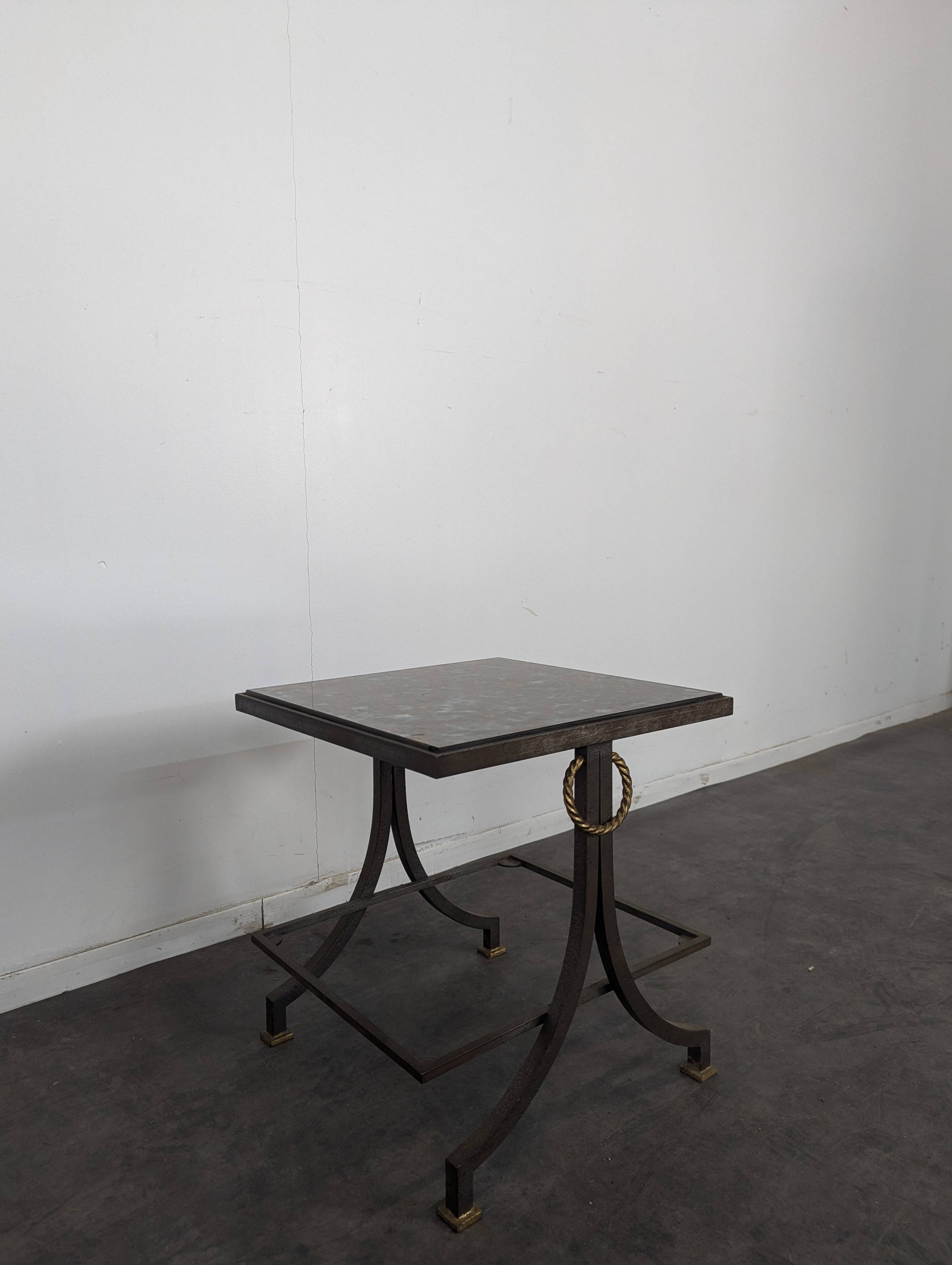Neoclassical side table in wrought iron and eglomisé glass.