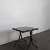 Neoclassical side table in wrought iron and eglomisé glass.