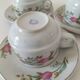 Trio of floral porcelain cups and saucers