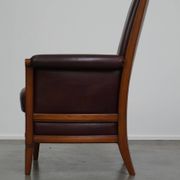 Very comfortable classic cowhide armchair with a high back in a mild Art Deco style