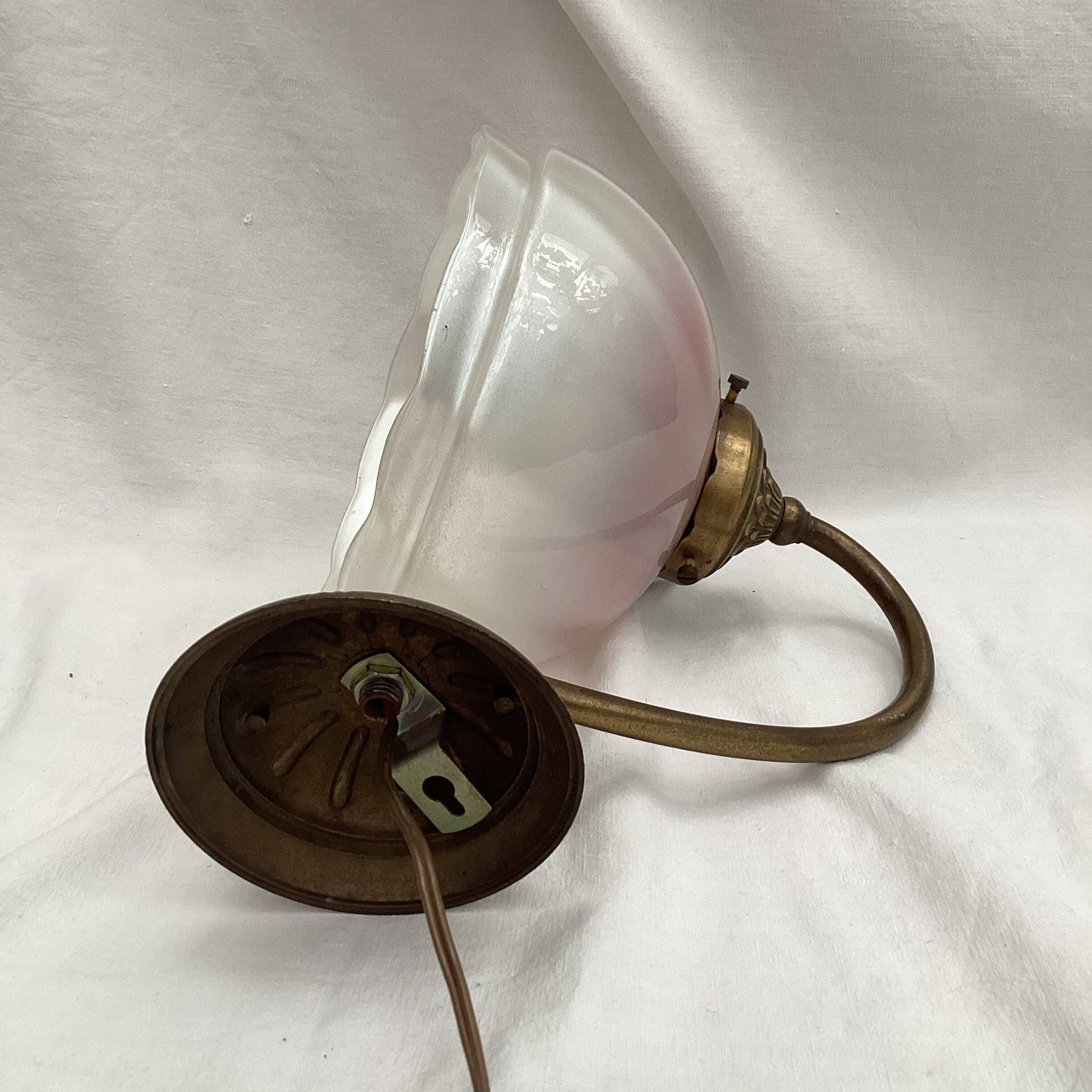 Brass wall light with a glass globe dimension: height -21cm- width -27cm-