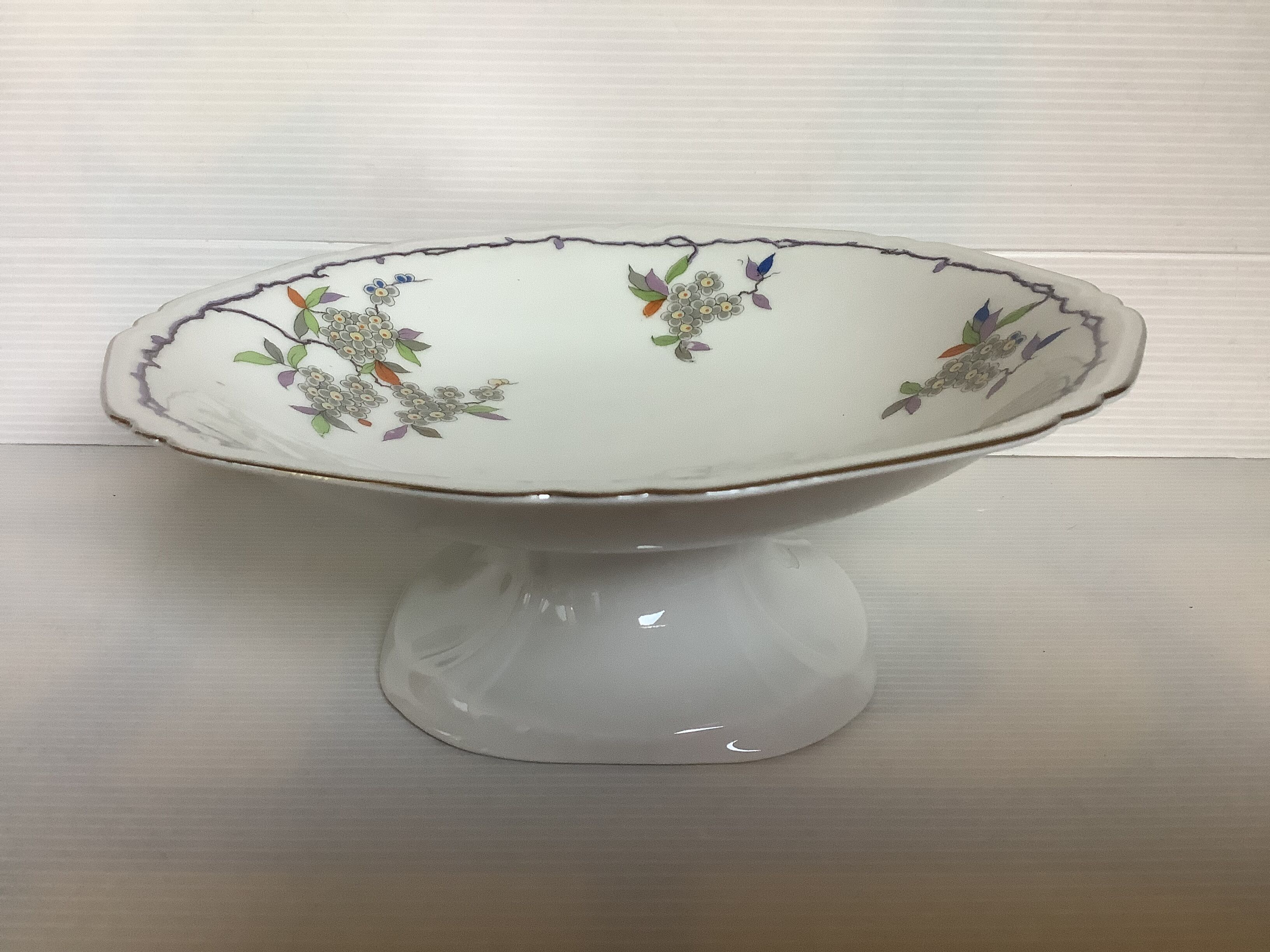 Old footed dish with gypsophila, white flowers.