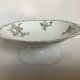 Old footed dish with gypsophila, white flowers.