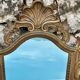 Carved and gilded wooden wall mirror.