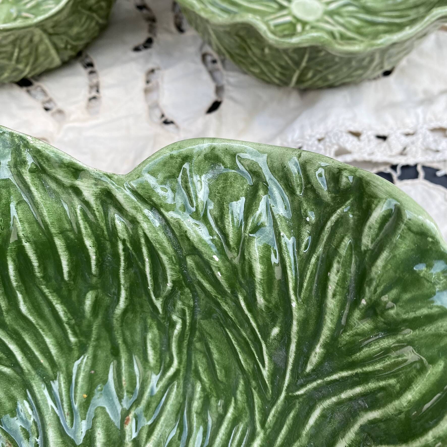 Large earthenware salad bowl in the shape of a cabbage leaf.
