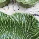 Large earthenware salad bowl in the shape of a cabbage leaf.