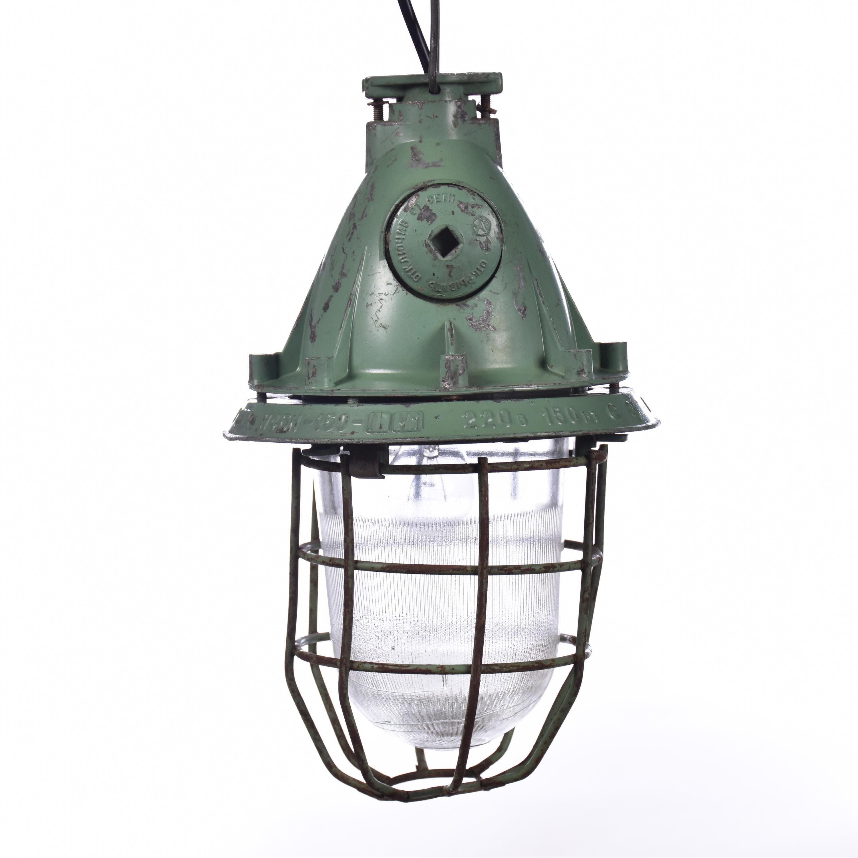Industrial caged green lamp