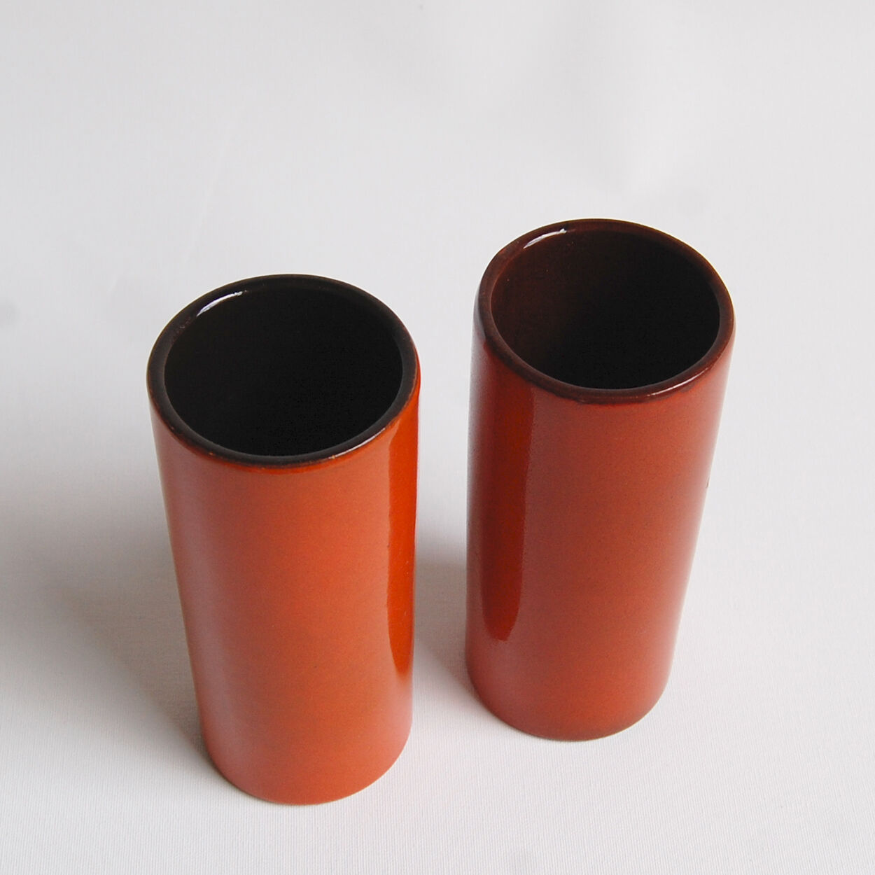 Pair of orange roll vases