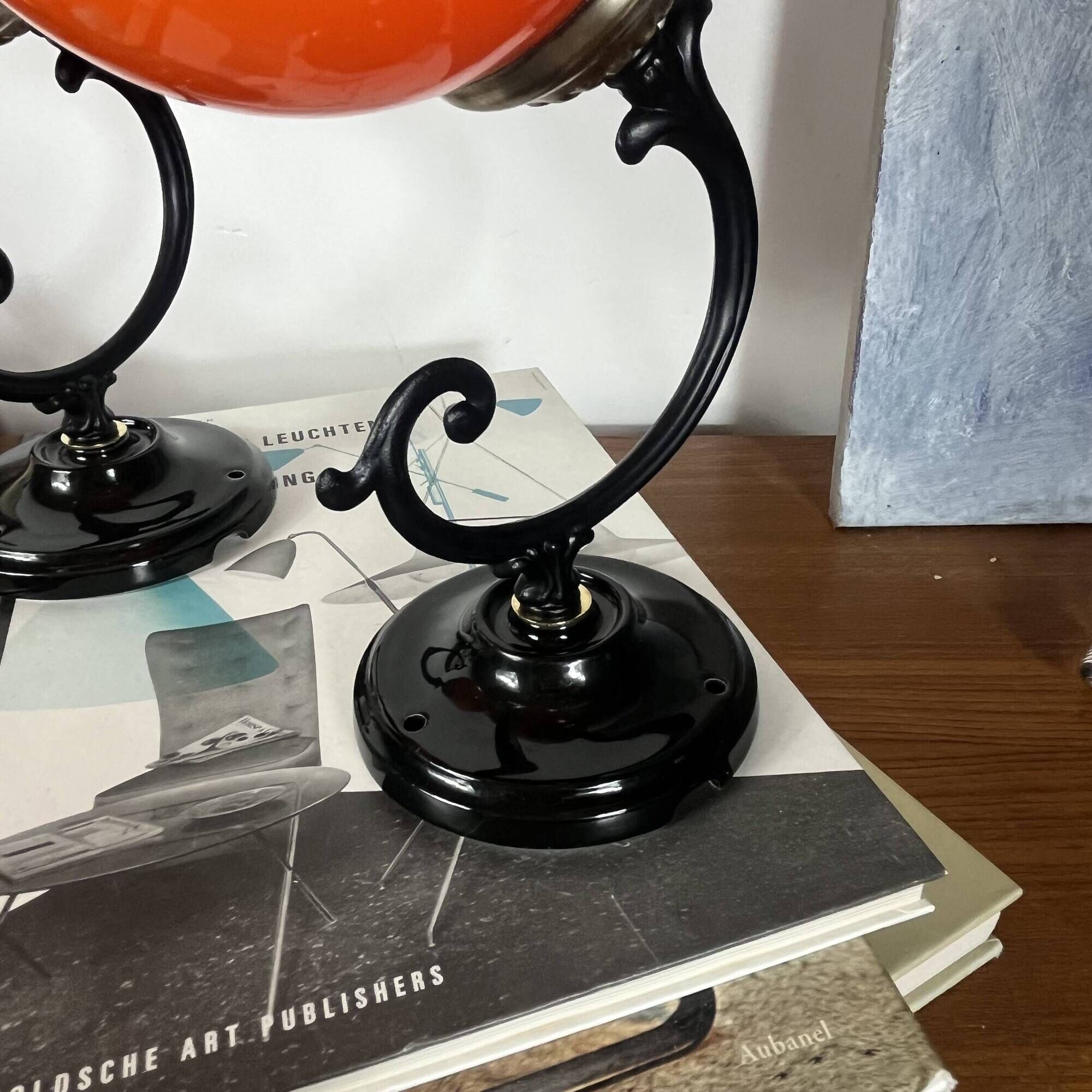 Pair of wall sconces with orange opaline globes and porcelain rose.