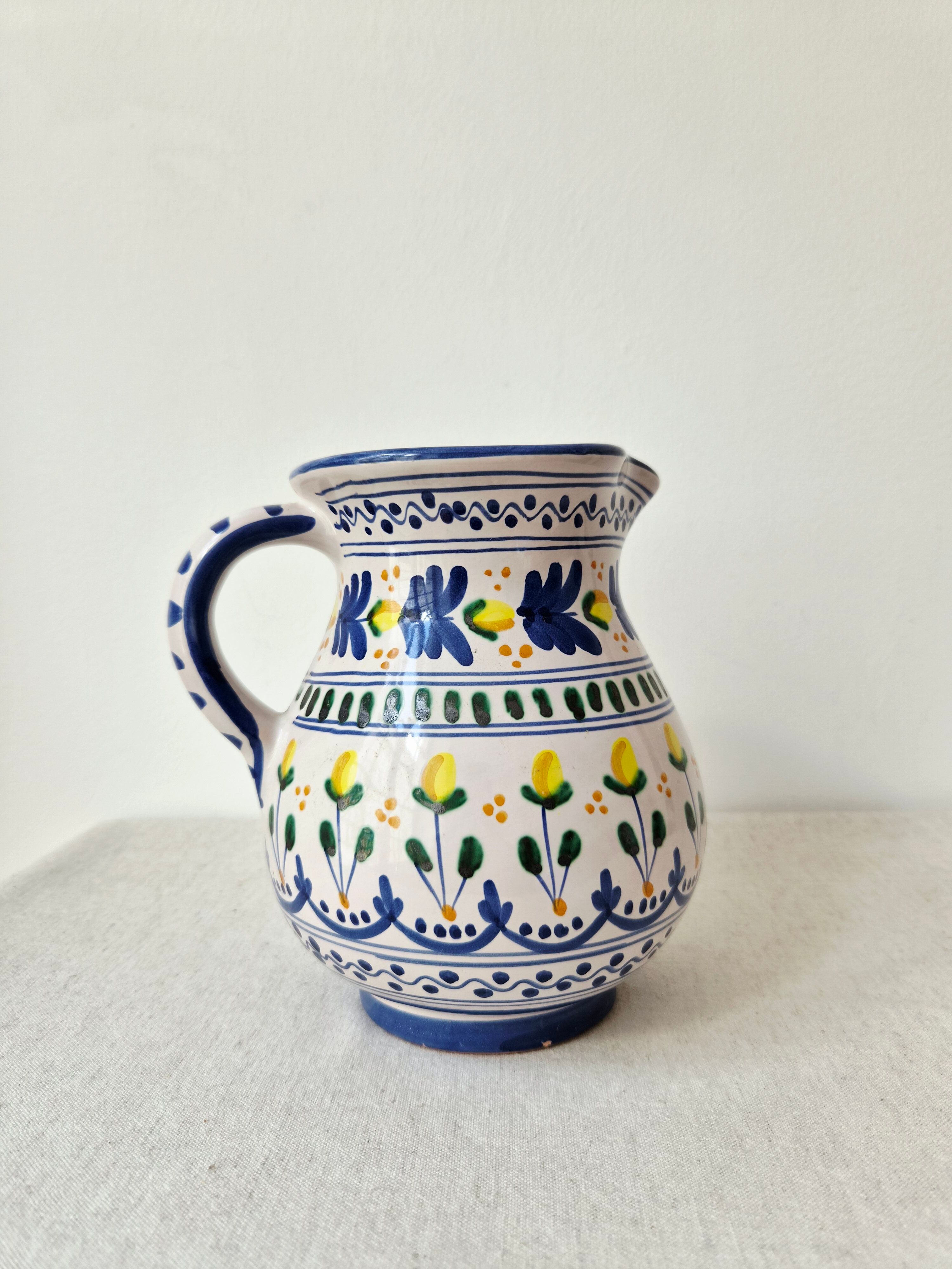 Vintage ceramic pitcher/vase hand-painted with floral decoration.
