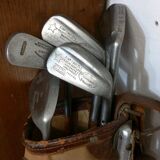 Old golf bag with 5 golf clubs