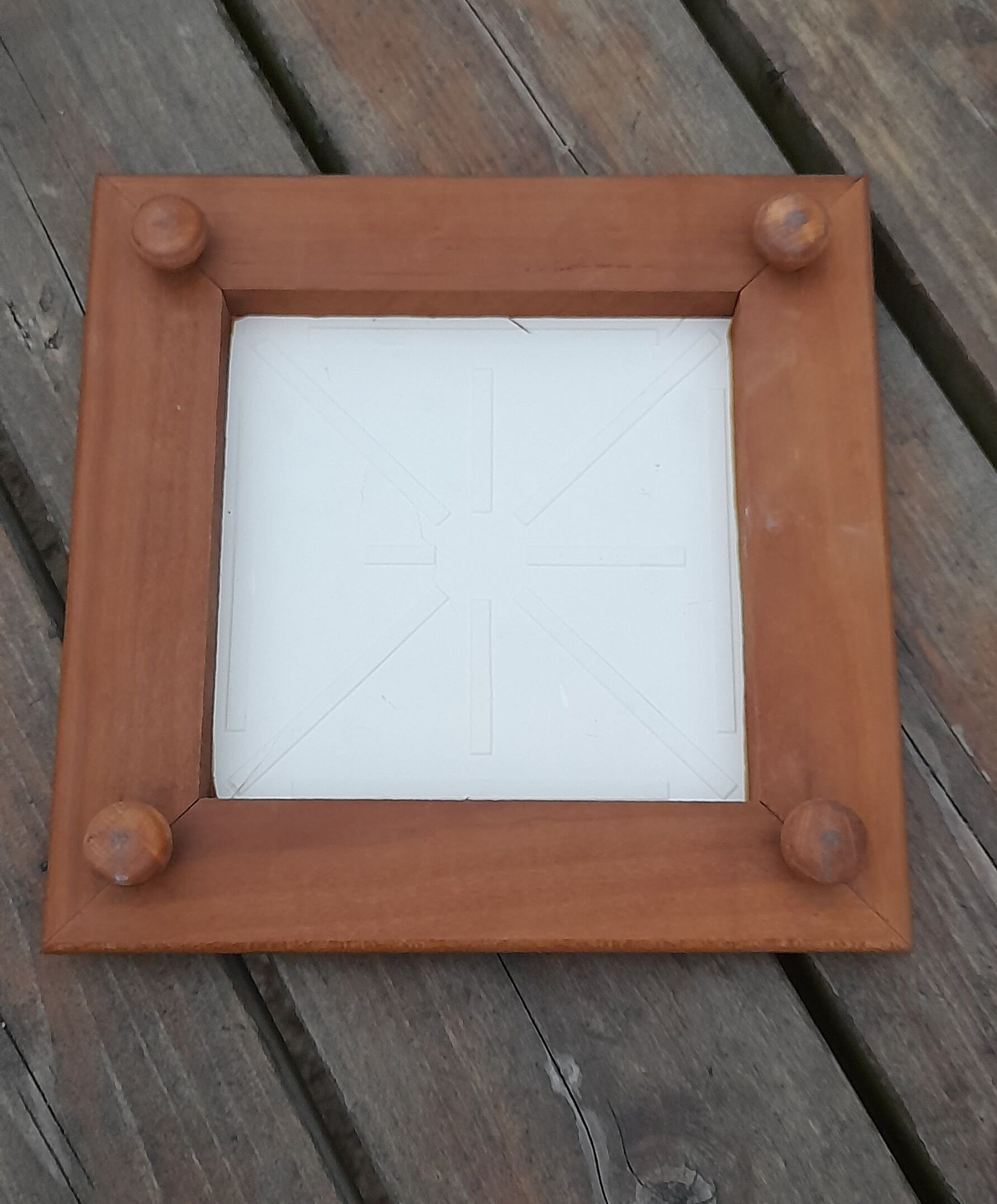 Underside of flat wood and faience floral pattern - retro