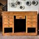 Counter, glass-fronted wooden workbench in dark wood, 8 drawers.