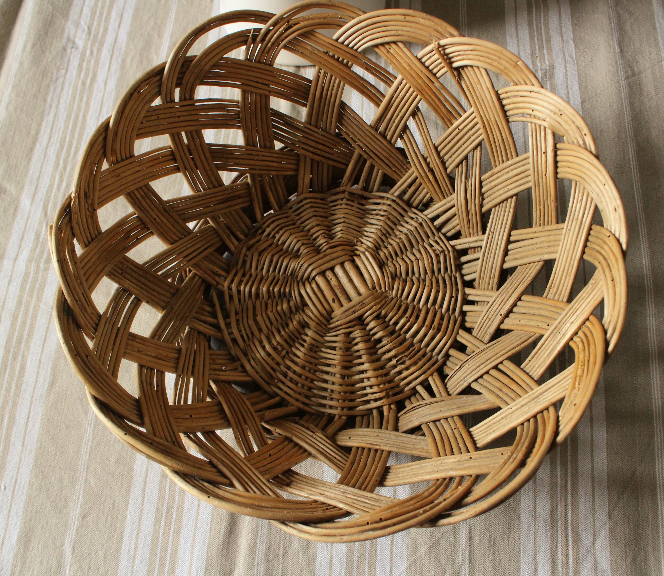 Large vintage twisted wicker basket on a stand