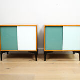 A pair of vintage mid-century bedside tables with glass sliding doors