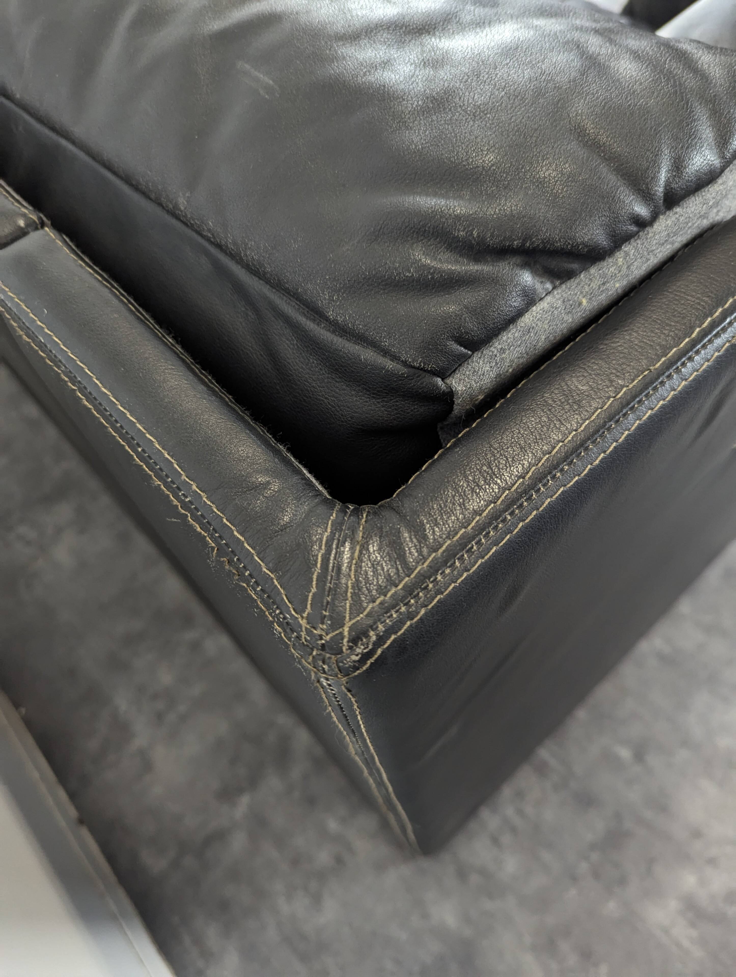 Black leather convertible sofa with goose feather upholstery.