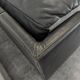 Black leather convertible sofa with goose feather upholstery.