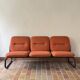 Strafor 3-seater bench, orange upholstery and sled base, 1970s.