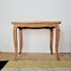 Antique coffee table with curved legs.