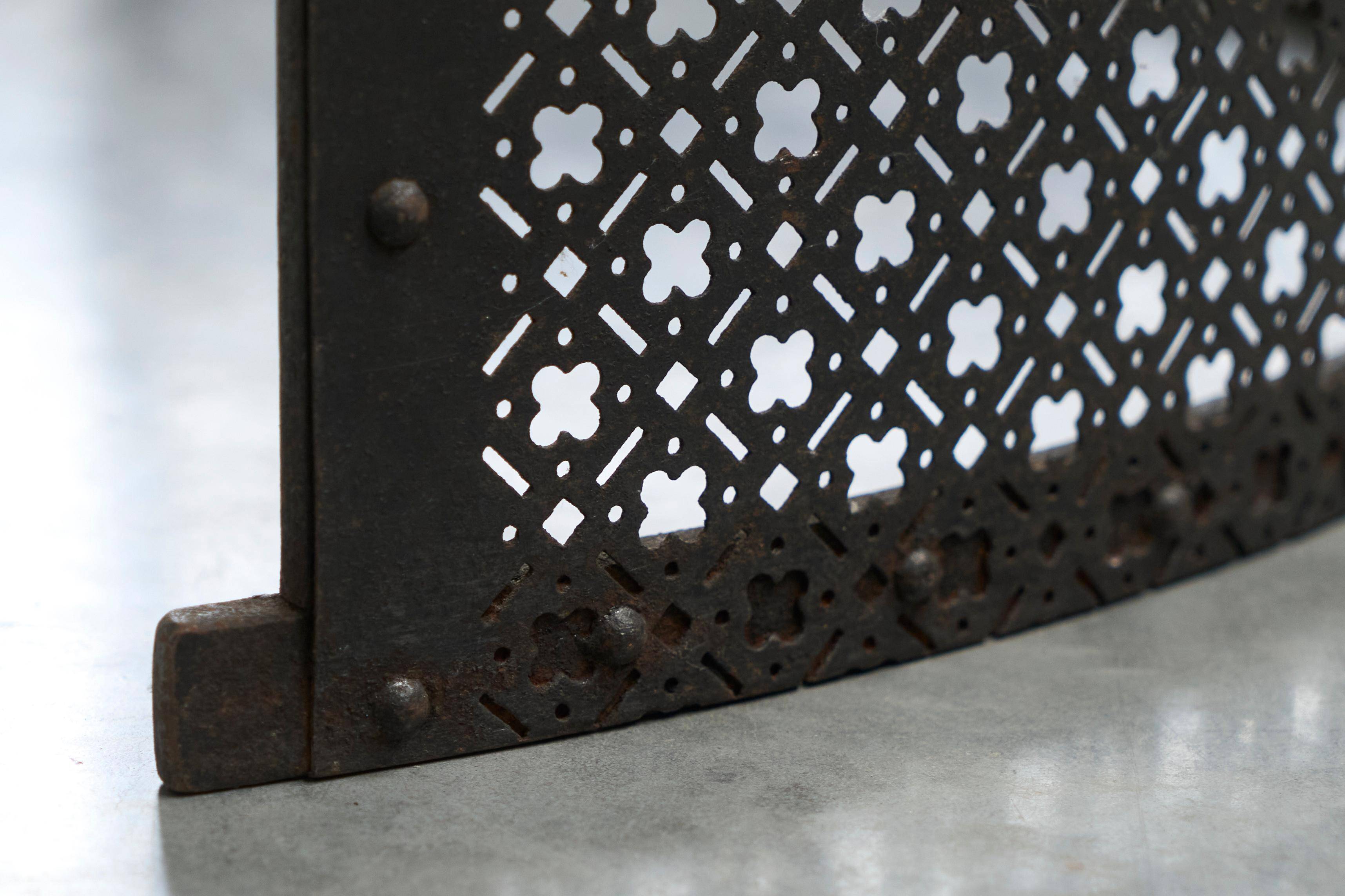 Half-moon antique wrought iron fire screen from the 19th century.