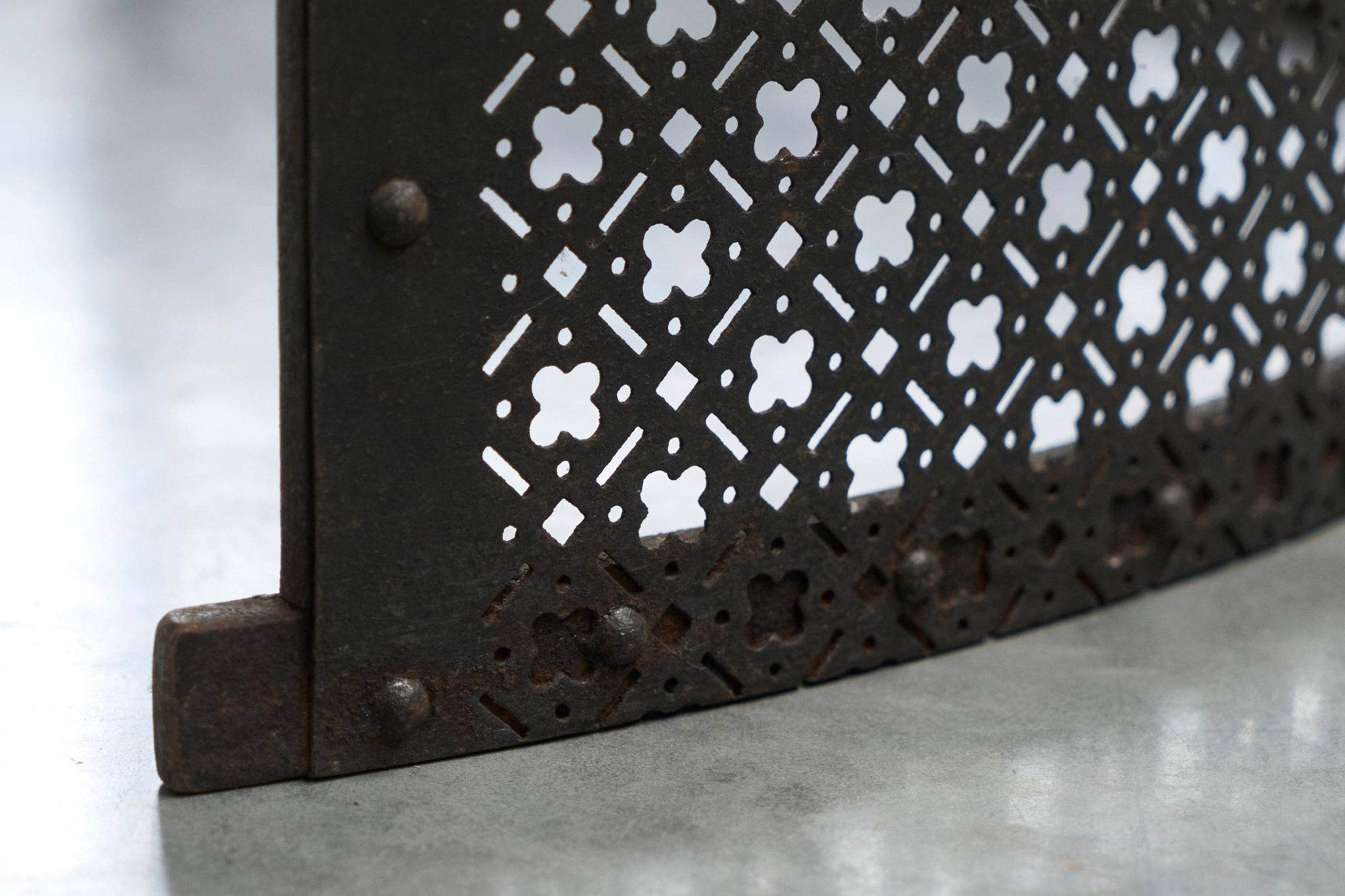 Half-moon antique wrought iron fire screen from the 19th century.
