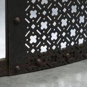 Half-moon antique wrought iron fire screen from the 19th century.
