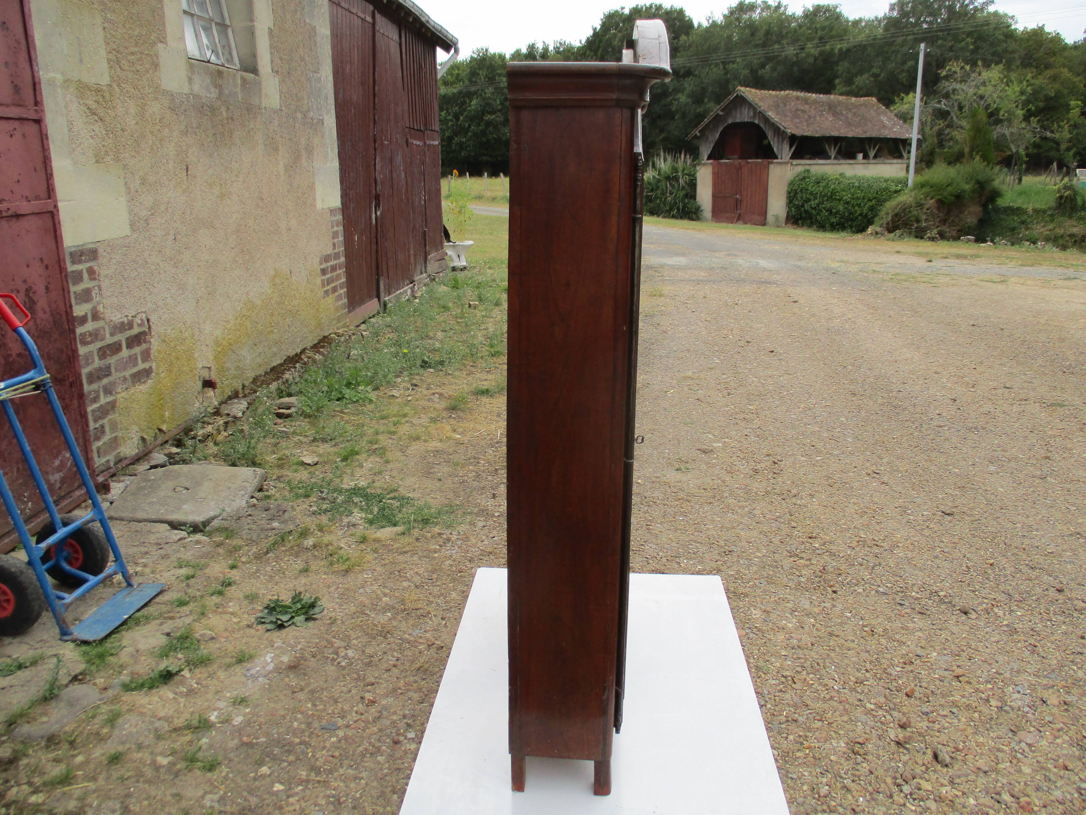 Small solid wooden cabinet with a gendarme hat