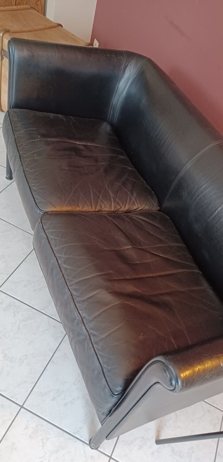 Black leather two-seater sofa