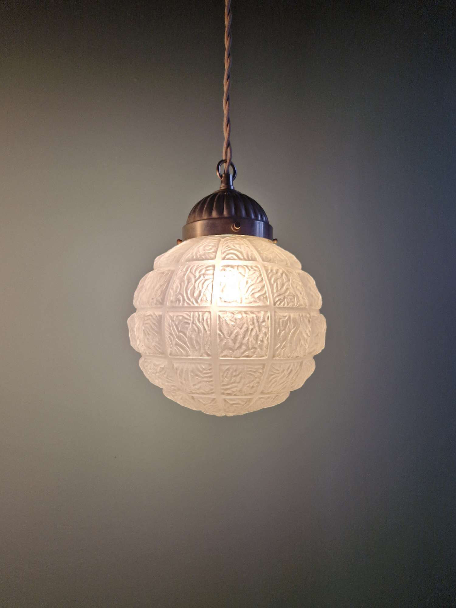 Art Deco trio of frosted glass pendants, 1920s-30s.