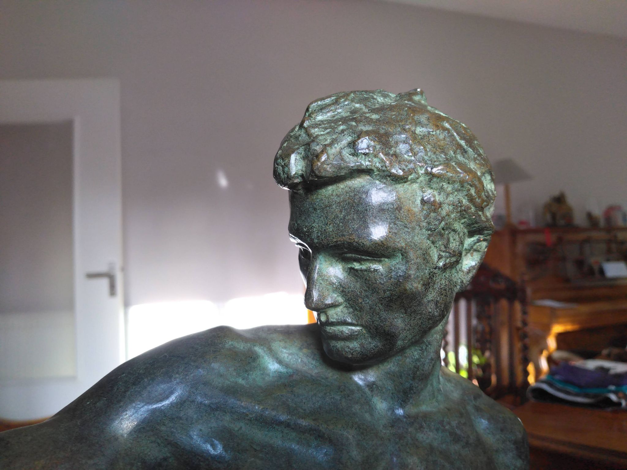 bronze sculpture athlete bending an iron bar by Jean de Roncourt on an art deco marble base