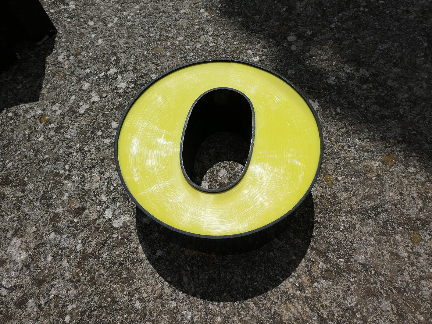 Yellow and black industrial sign "O" letter