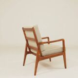 Vintage armchair in olive corduroy with a wooden frame.