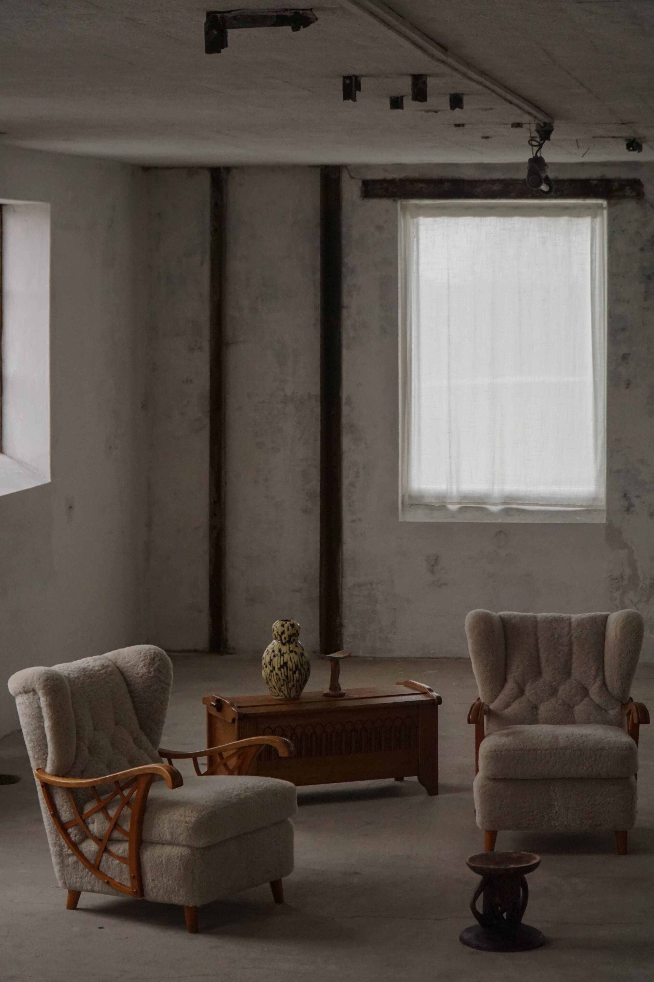 Pair of modern Swedish lounge chairs, shearling sheepskin and elm, 1940s.