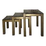 Trio of nesting tables, brass structures and smoked mirror tops