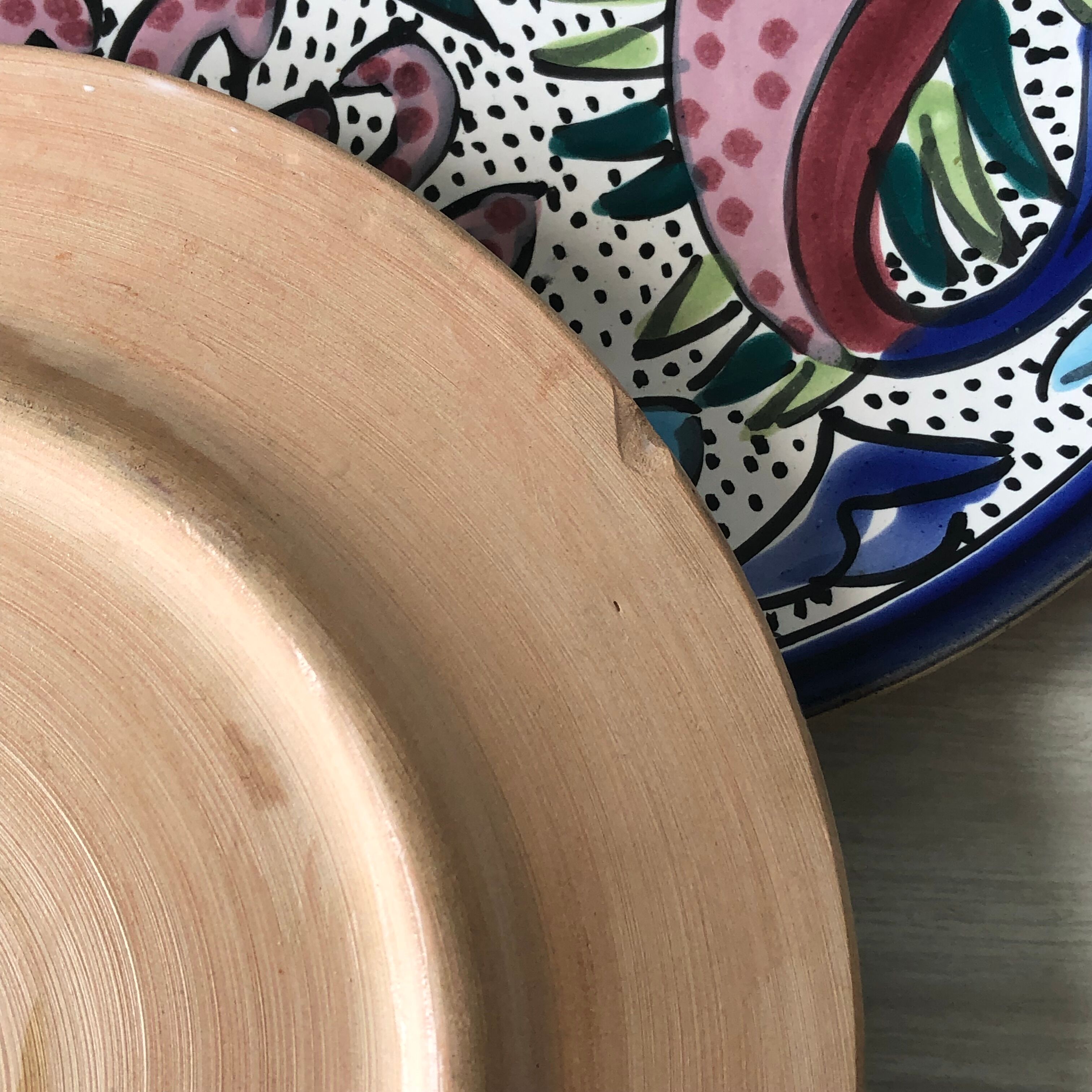 4 colorful flat plates with a fish pattern