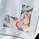 Embroidered tablecloth and open fruit decoration - 12 assorted towels
