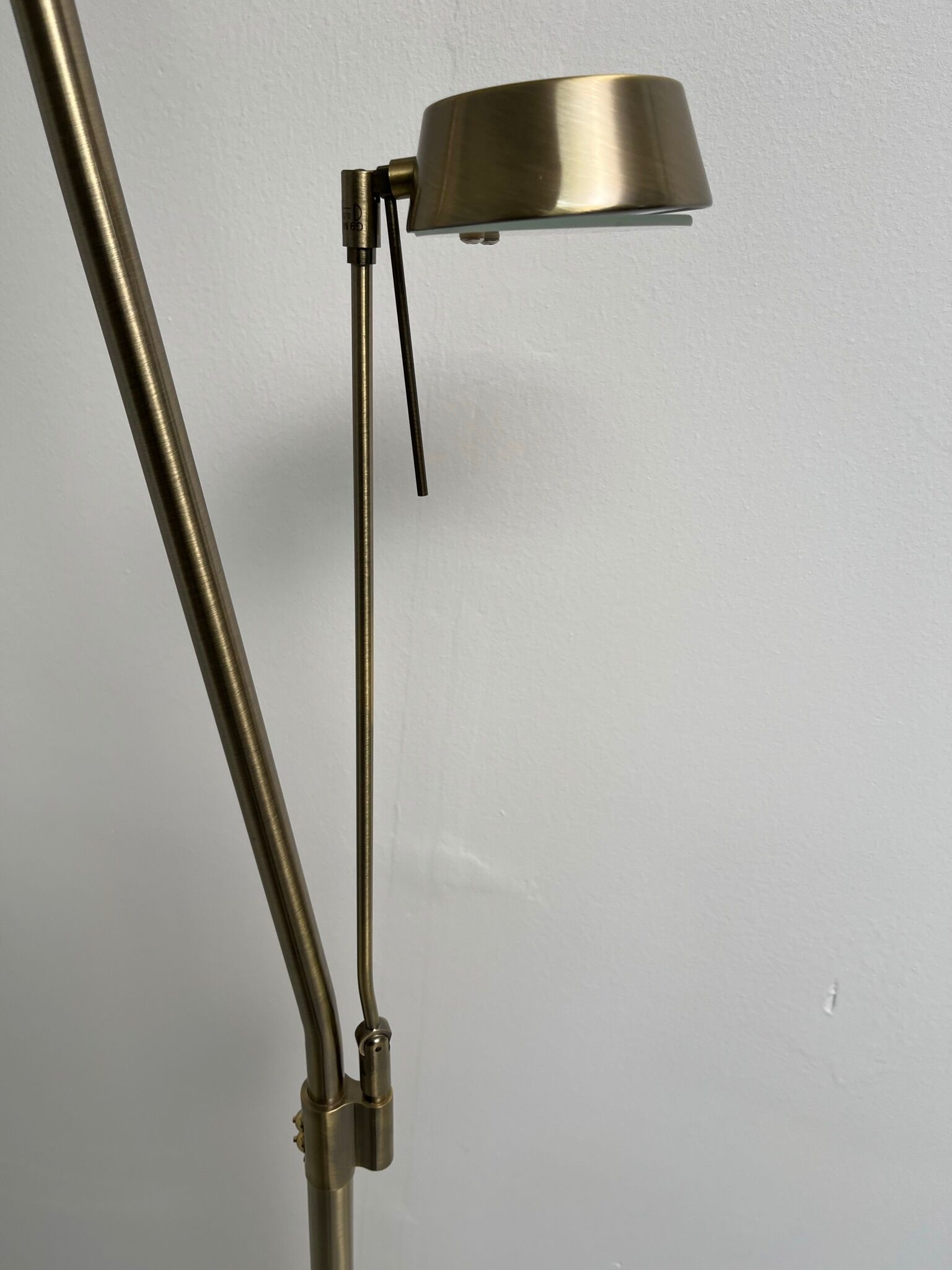 Golden metal floor lamp with reading light