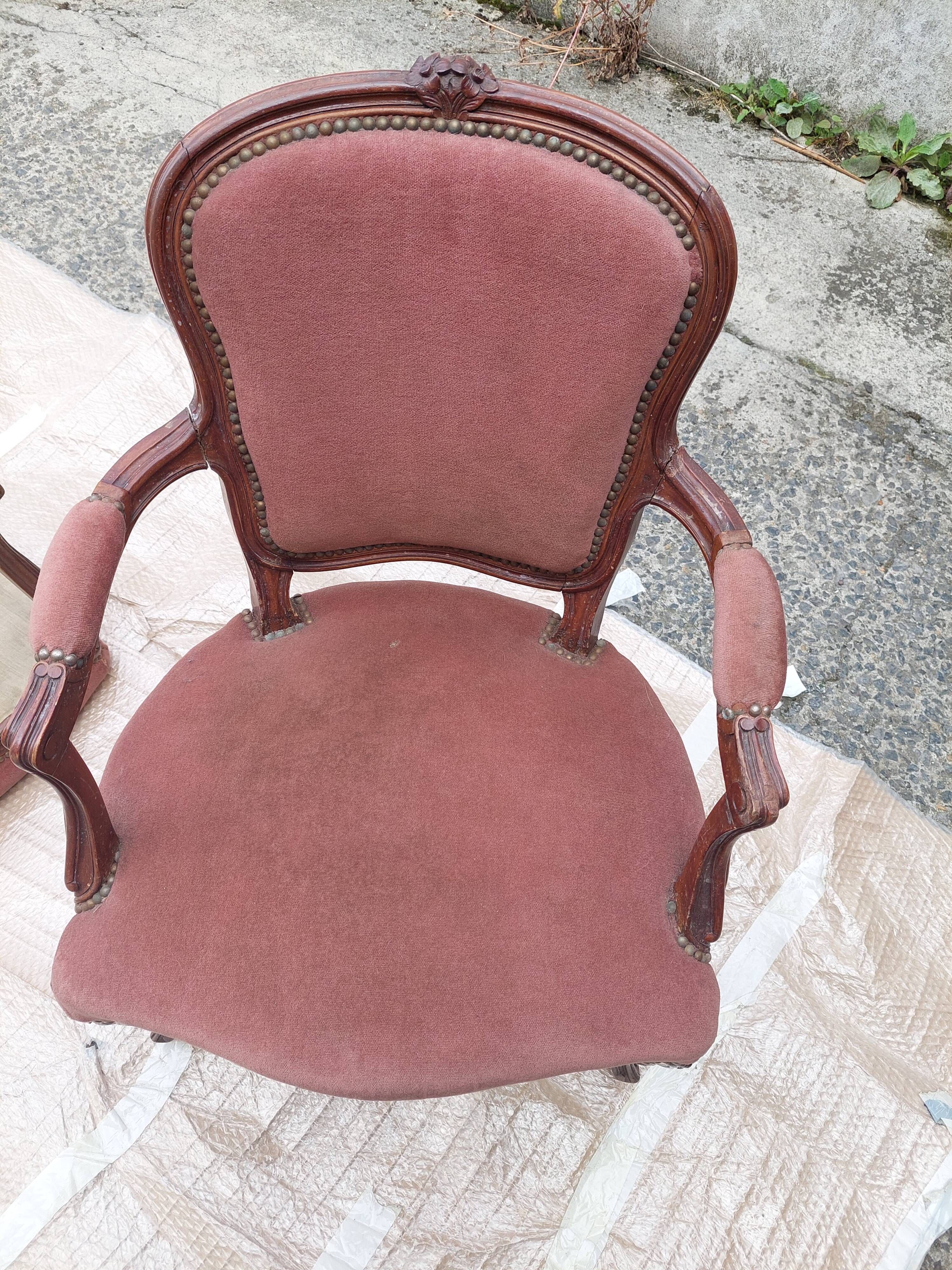 Pair of armchairs with Louis Philippe style footrests in walnut