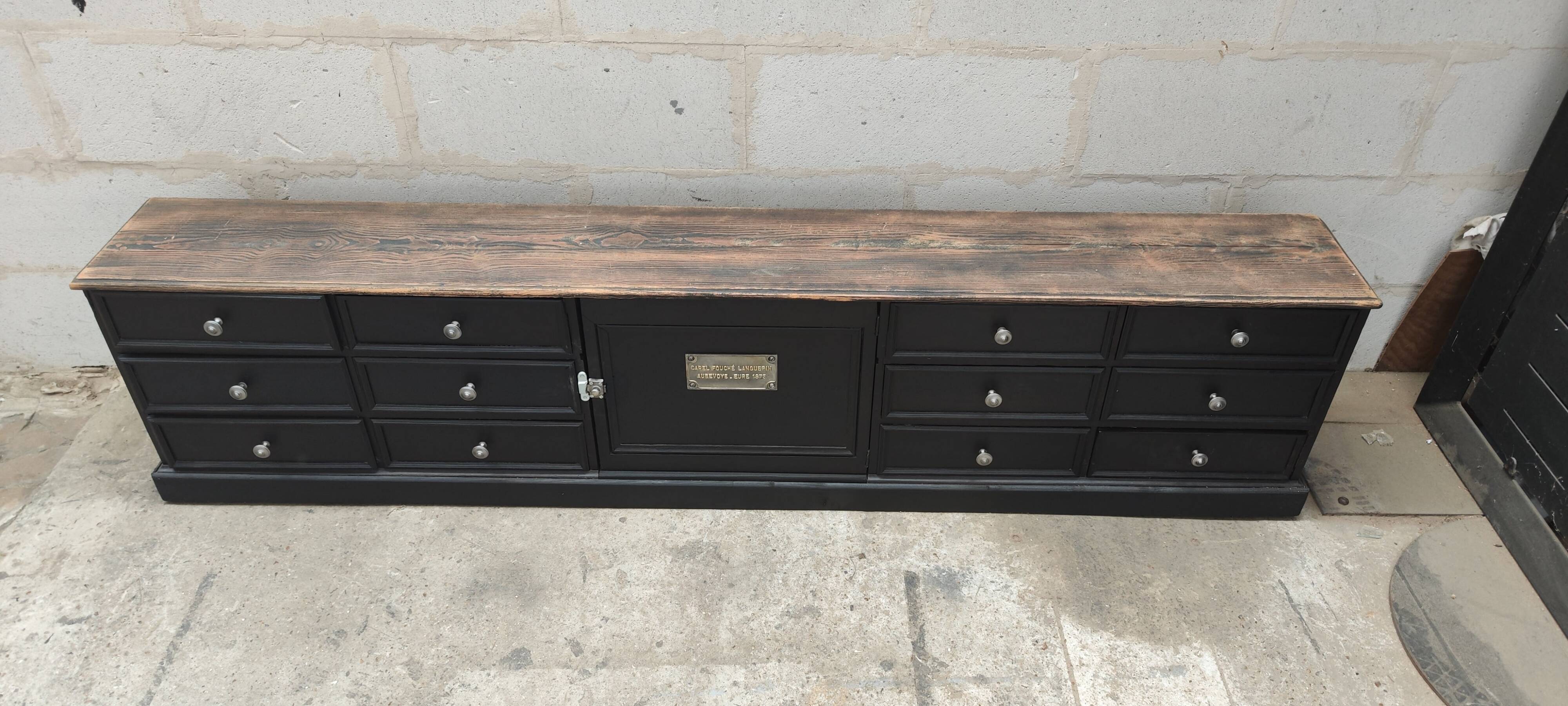Low TV cabinet with black patina, twelve drawers and one door