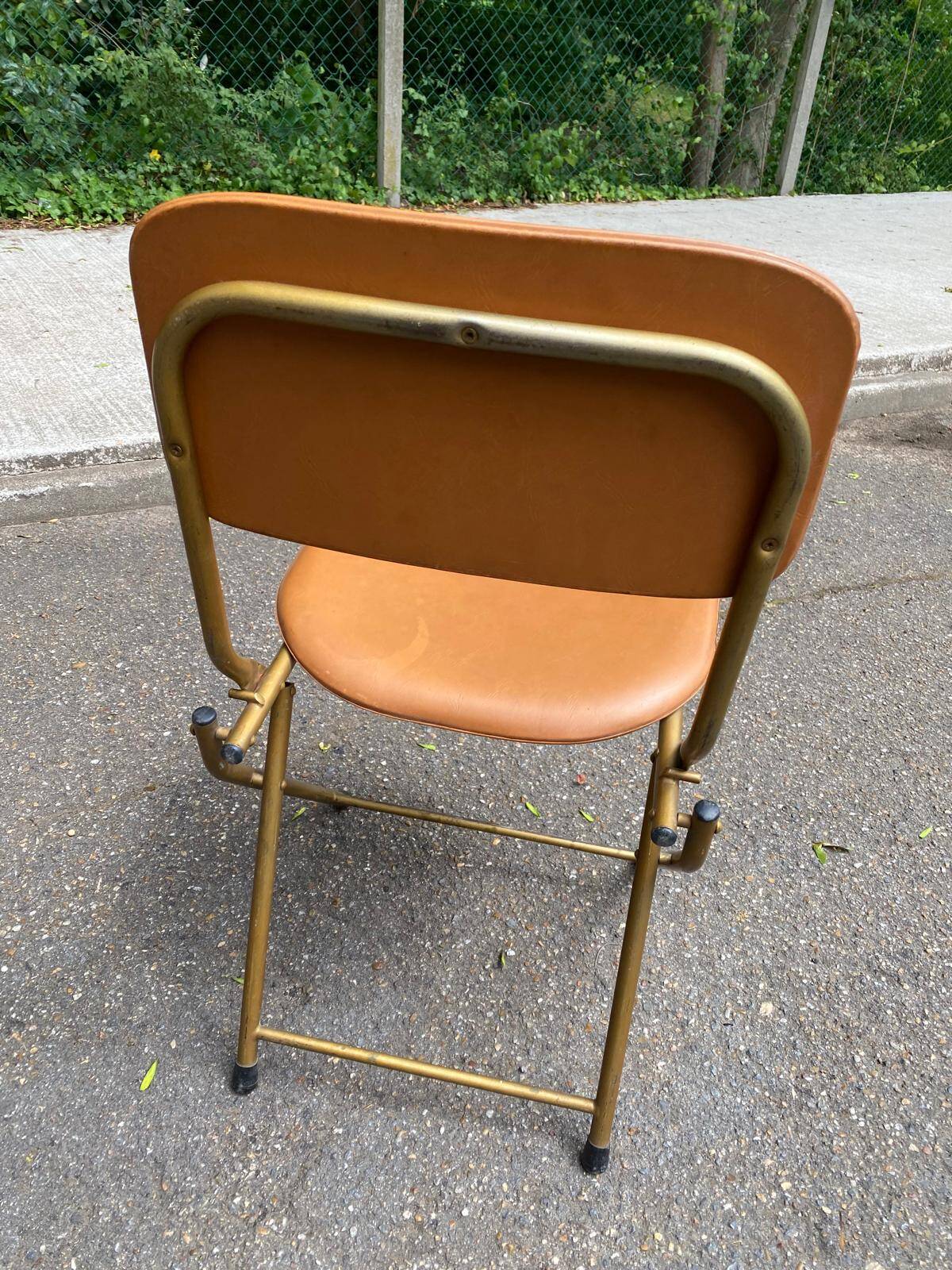 Eyrel folding chair in brass and leather from the 1960s.