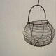 Basket with salad or old eggs in wire