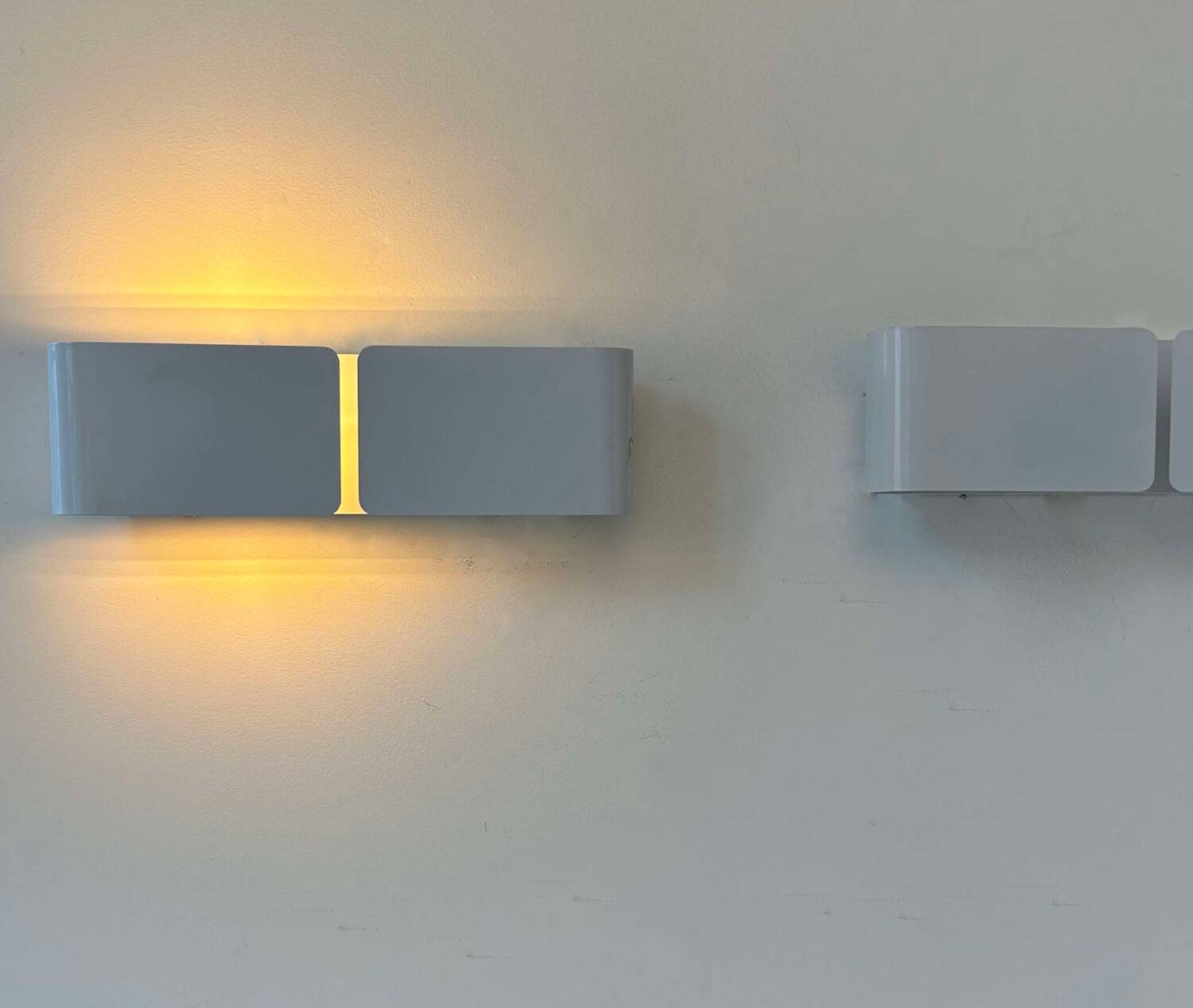 Pair of vintage wall lights, curved white metal, France 1980