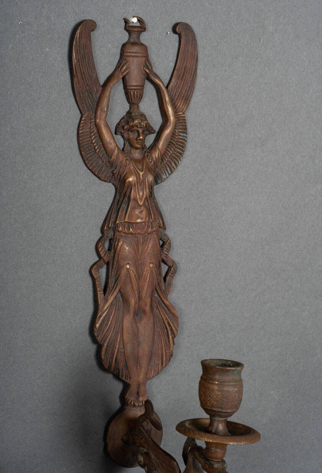 Pair of Empire period bronze sconces decorated with a winged woman