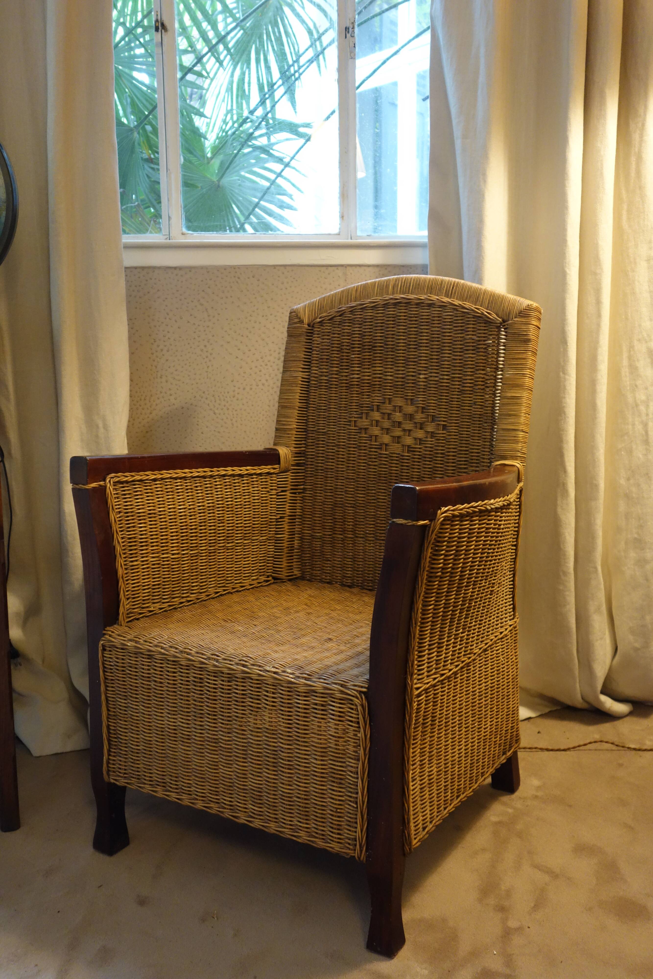 comfortable colonial-style armchair in rattan and mahogany