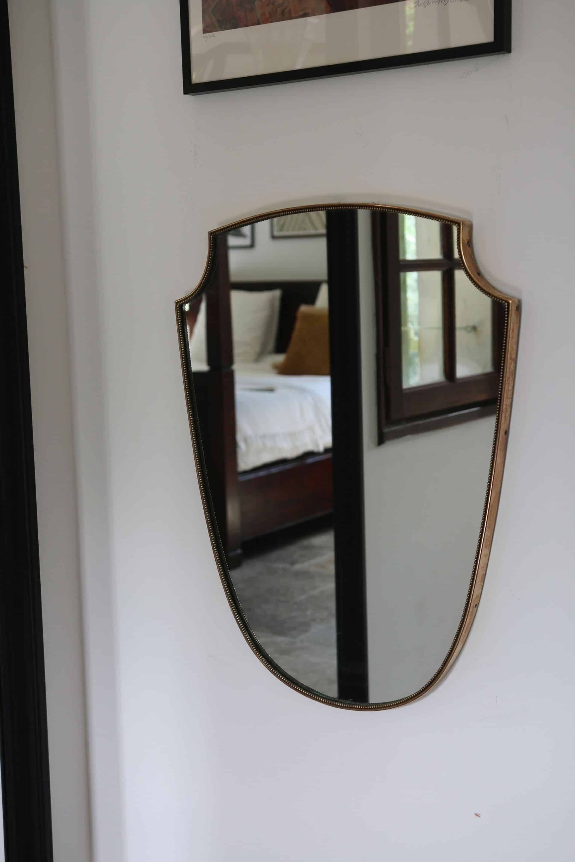 Brass mirror with crest, bead frieze, Italian design style.