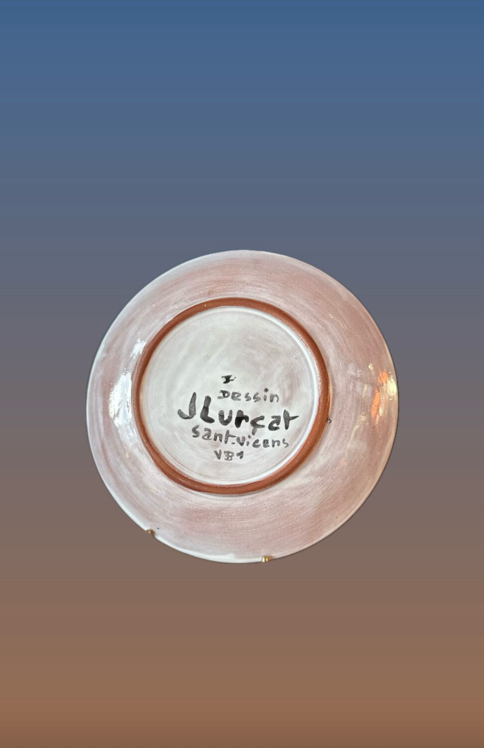 Terracotta plate, Jean Lurçat decorated with a character on a white background.