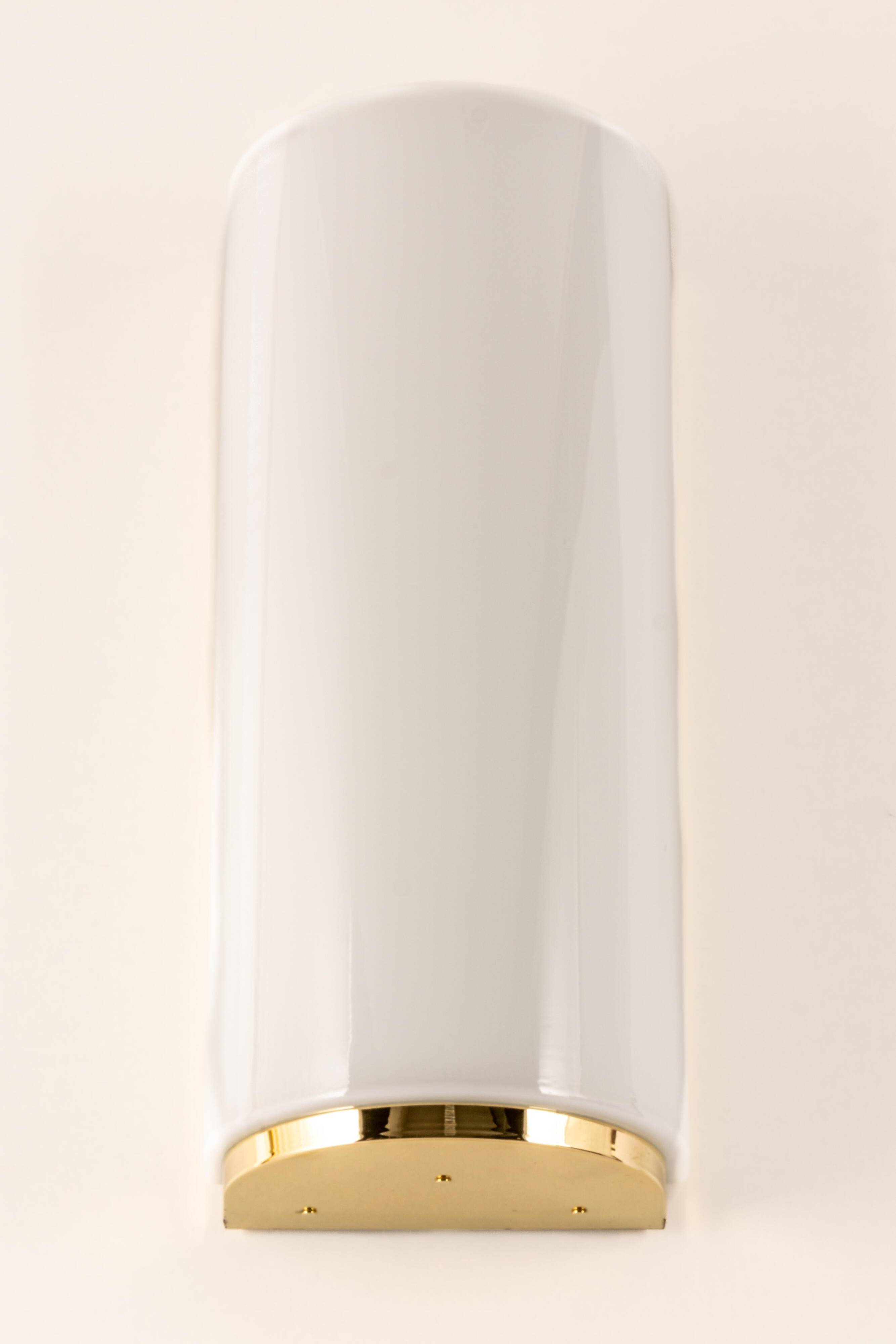 Pair of large opaline glass wall lights in brass designed by Limburg, Germany.